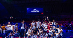 Jake Hanes of the USA team spikes the ball during a match
