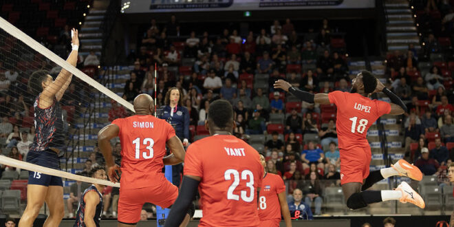 Volleyball players from Canada and Cuba competing at the net during a match