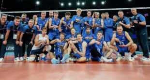 Finnish volleyball player spikes the ball during a match against Denmark