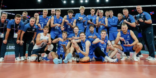 Finnish volleyball player spikes the ball during a match against Denmark