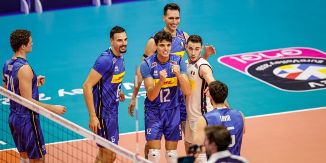 Volleyball players from Finland and Greece competing at the net during a EuroVolley match.