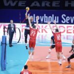 Volleyball players in action during a tense match