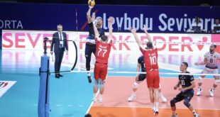 Volleyball players in action during a tense match