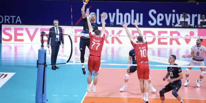 Volleyball players in action during a tense match