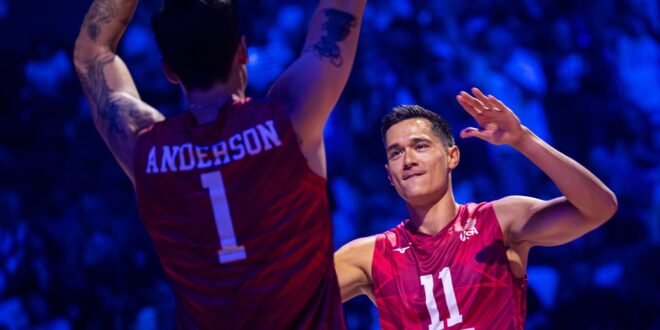 Men's volleyball players celebrating on the court