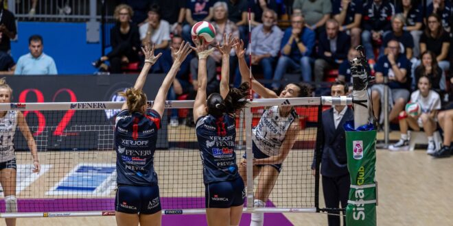 A volleyball player spikes the ball during a match.